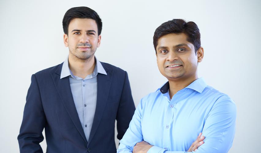 Two Indian EB5 investors smiling at the camera, illustrating the impact of H1B visa uncertainties on skilled Indian workers and how EB5AN can help.
