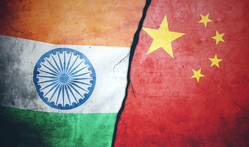 An image of the Indian and Chinese flags separated by a crack, symbolizing visa retrogression and long waiting times for EB5 applicants from these high-demand countries.