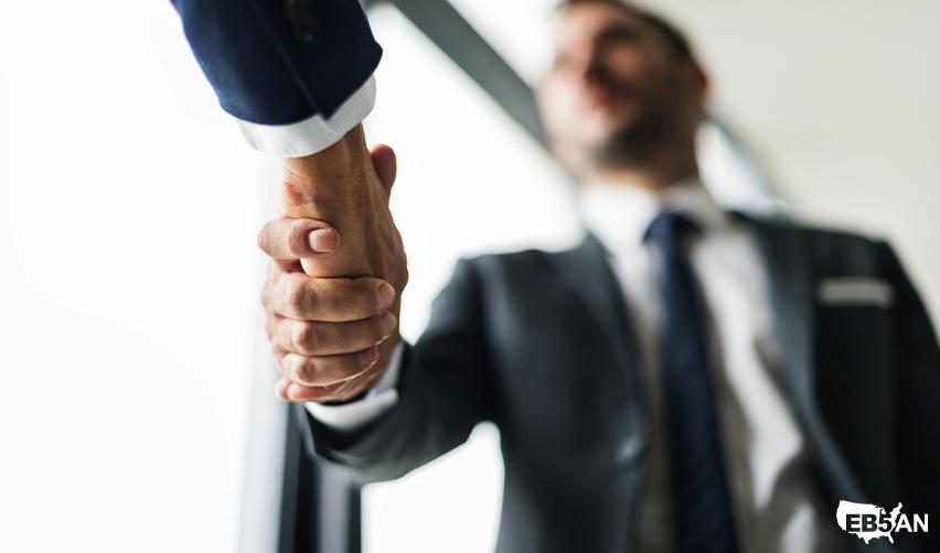 EB5 regional center industry professional and EB5 investor shaking hands with the EB5AN logo on the corner, representing successful EB5 investments and partnerships in low-risk rural projects.