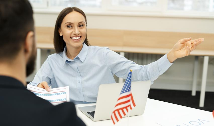 A friendly immigration officer discussing visa options with a Canadian resident, emphasizing pathways such as family sponsorship and employment-based visas for professionals with a job offer in the U.S.