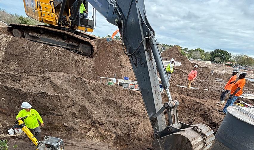 A construction site with a bulldozer digging a hole