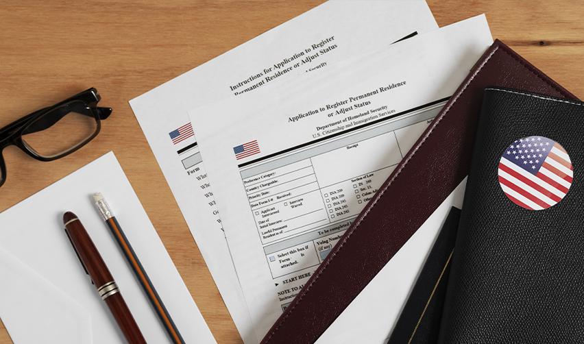 A close-up of immigration forms and legal documents required for Canadian citizens adjusting their status in the U.S., demonstrating the importance of proper paperwork and expert immigration services.