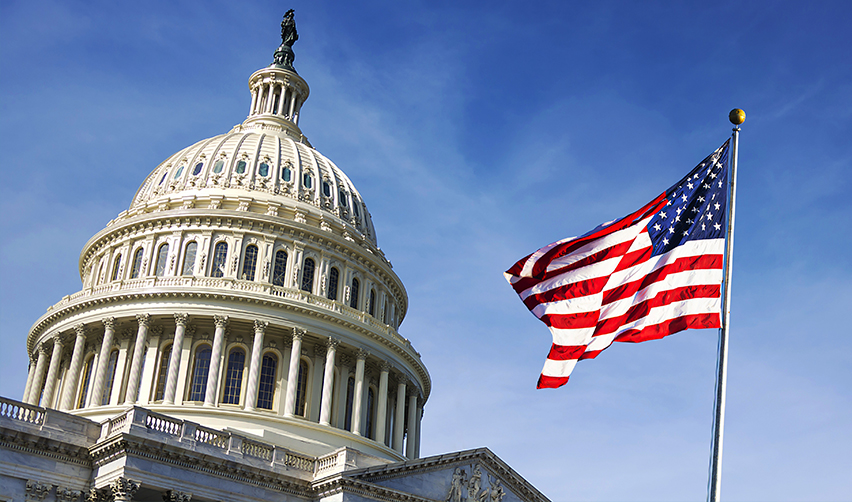 The United States Capitol building with the American flag waving in front, highlighting legislative stability supporting the EB5 immigration program.