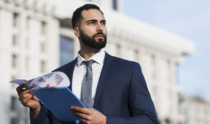 Confident investor reviewing financial charts outdoors, representing global professionals evaluating EB5 investment opportunities.