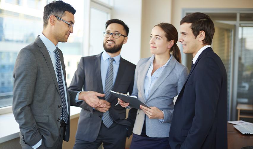 A group of entrepreneurs and executives discussing EB5 regional center program options and permanent residence pathways in a modern office setting.