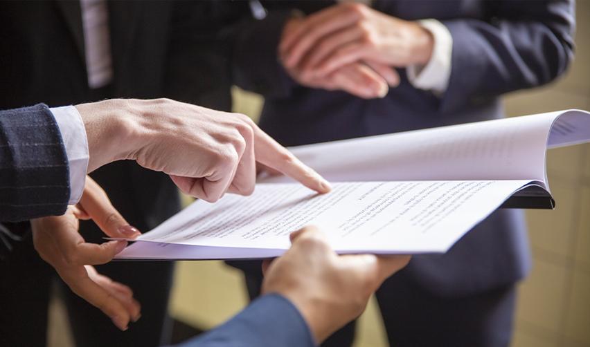 Regional center professionals reviewing investment documents, highlighting the need to scrutinize EB5 project paperwork and avoid developer-controlled projects.