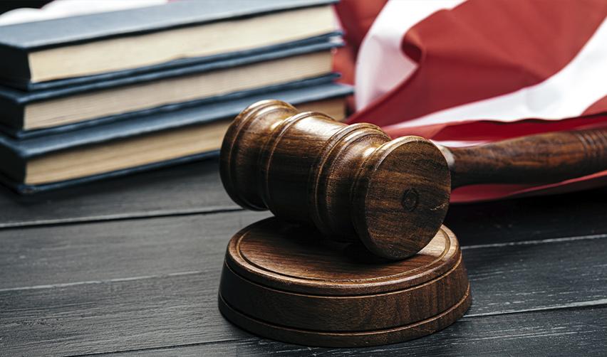 Legal concept of immigration status and unlawful presence in the U.S., symbolized by a judge's gavel, law books, and the American flag.