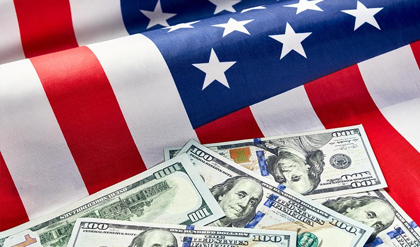 American flag with U.S. hundred-dollar bills, representing the EB5 investment requirement for Canadian nationals seeking U.S. permanent residency.