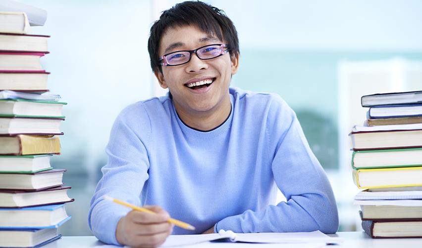 Happy international student planning for future Green Card options through the EB5 program with EB5AN.
