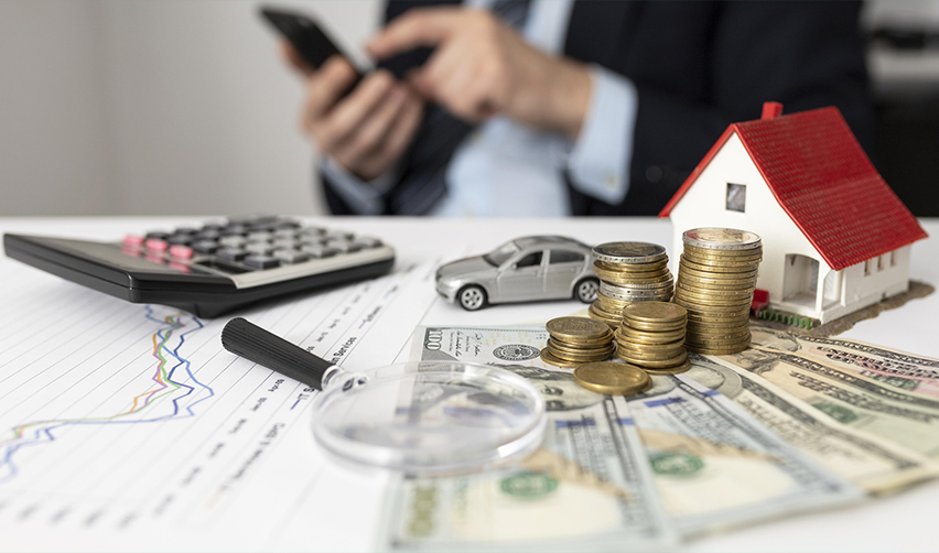Financial planning concept with coins, calculator, house model, and investment charts for EB5 projects, especially highlighting the role of real estate developers in mixed-use development.