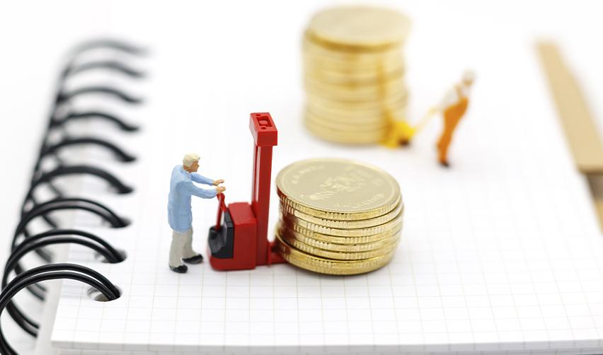 Miniature figures moving stacked gold coins, symbolizing financial backing and stability in EB5 investment projects.