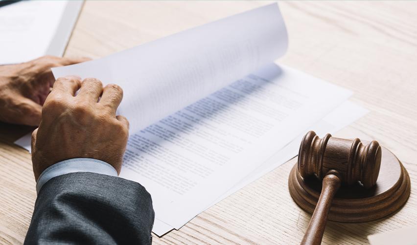 Close-up of legal paperwork and a judge’s gavel on a desk, highlighting the legal and compliance aspects of EB5 source of funds verification.