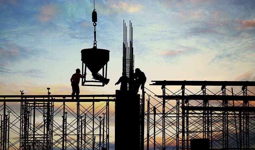 Construction workers on scaffolding at sunset, illustrating investment in U.S. regional center projects and job creation through Eb5 projects.