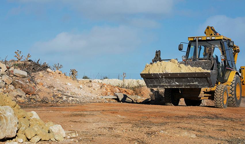 Bulldozer moving dirt at a residential construction site, representing progress in EB5AN Kolter EB5 projects.