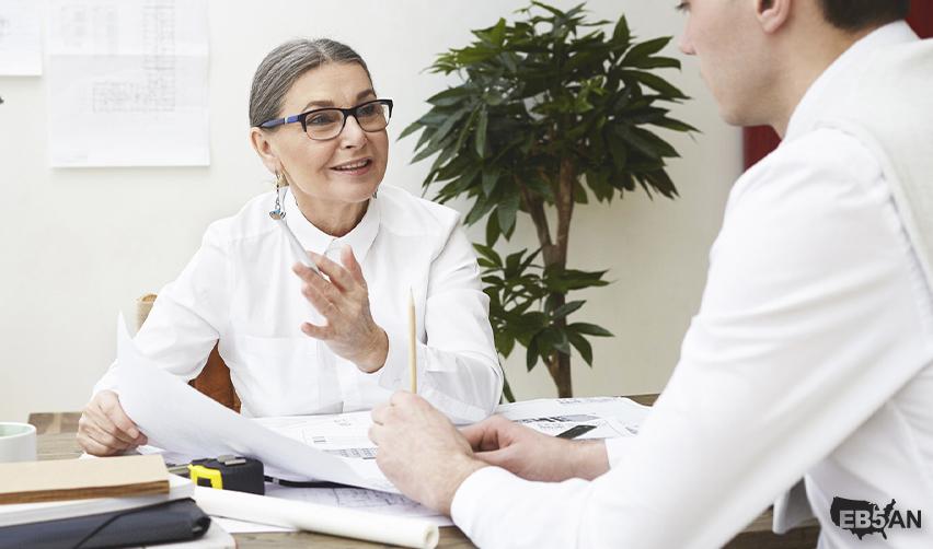 The EB5AN logo next to a professional advisor speaking with a client, representing expert guidance in the U.S. immigration or EB5 process.
