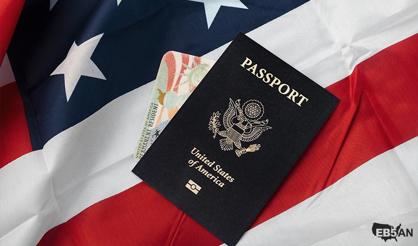 U.S. passport and permanent resident card on an American flag background, representing successful EB5 Green Card and eventual citizenship acquisition with the help of EB5AN.