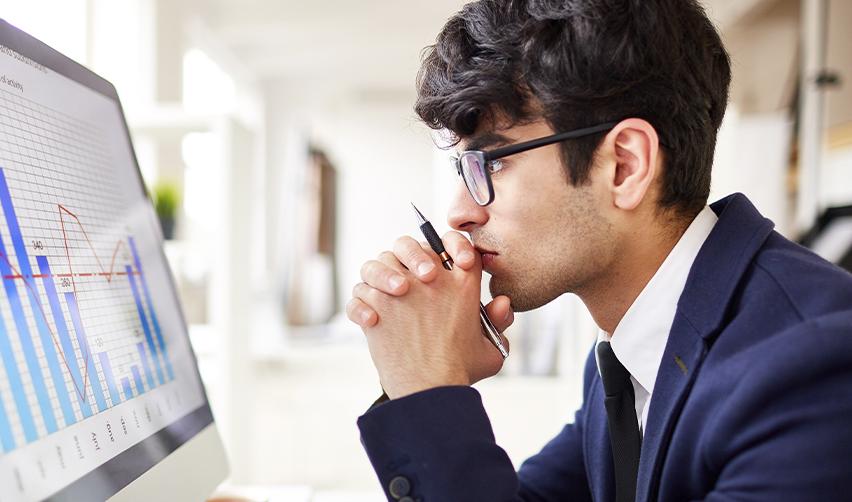 Focused EB5 applicant evaluating immigration risk and processing time trends through data charts, representing the shift toward rural visa category strategies.