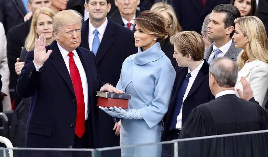 Donald Trump taking the oath of office surrounded by family, marking the start of the new catch and revoke immigration policy that affects visa holders across categories.