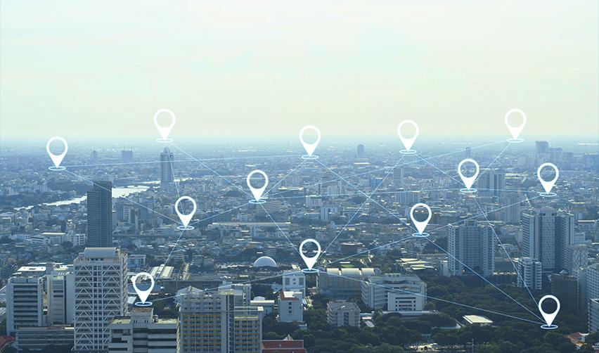 A city skyline overlaid with digital location markers, representing EB5 investors analyzing targeted employment area eligibility and visa set-aside locations for a new commercial enterprise..
