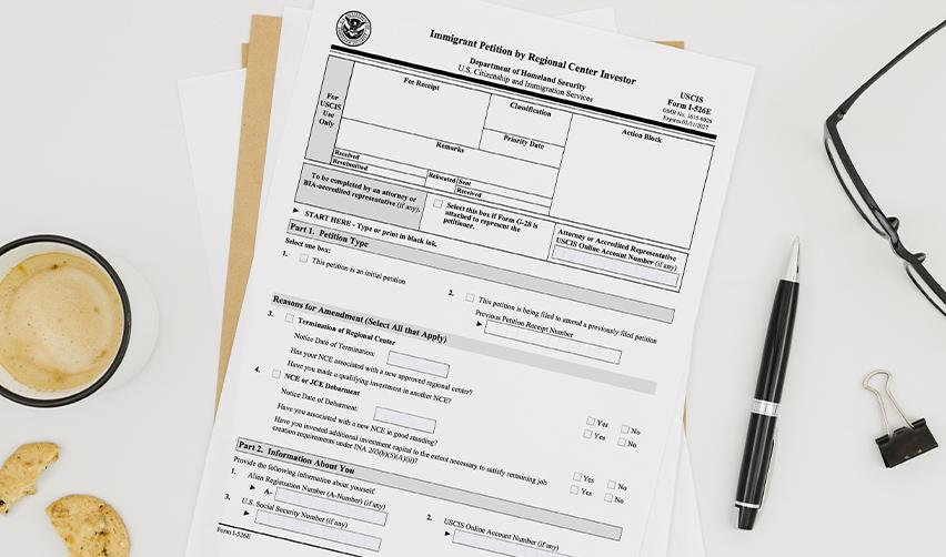 USCIS Form I-526E on a desk, representing the start of an EB5 immigration petition through the rural category.