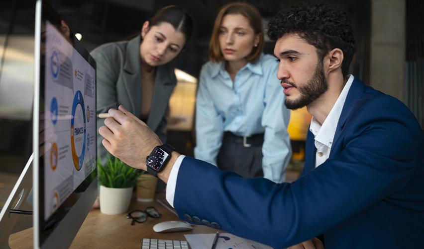 A team reviewing charts on a large screen during a strategy session, depicting experts assessing EB5 regional center performance and risk management options.