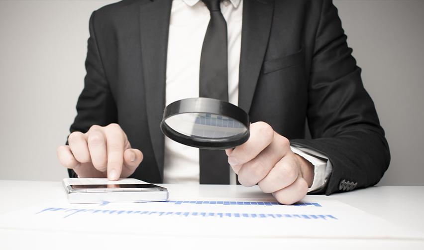 An EB5 investor closely reviewing financial charts and reports, emphasizing the role of due diligence in TEA project selection.