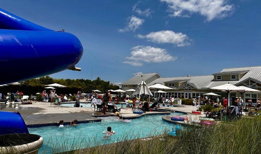 A wide angle shot of a fun day at the pool for residents and guests at the Bay Creek resort and EB5 rural TEA project in Cape Charles, Virginia.