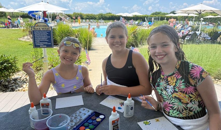 Children having fun participating at arts & crafts events by the pool in Bay Creek, Virginia.