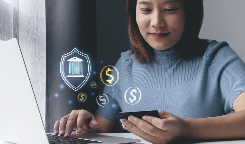Businesswoman making a secure online transaction on her laptop with financial icons, illustrating safe and transparent EB5 investment fund management.