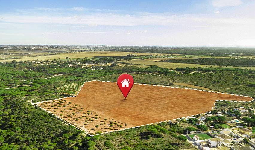 Aerial view of rural land with digital location marker, illustrating EB5 rural TEA investment opportunities available through regional centers.