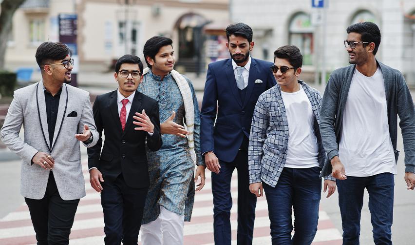Group of young men walking together in an urban setting, symbolizing global talent mobility and new opportunities through EB5 investment.