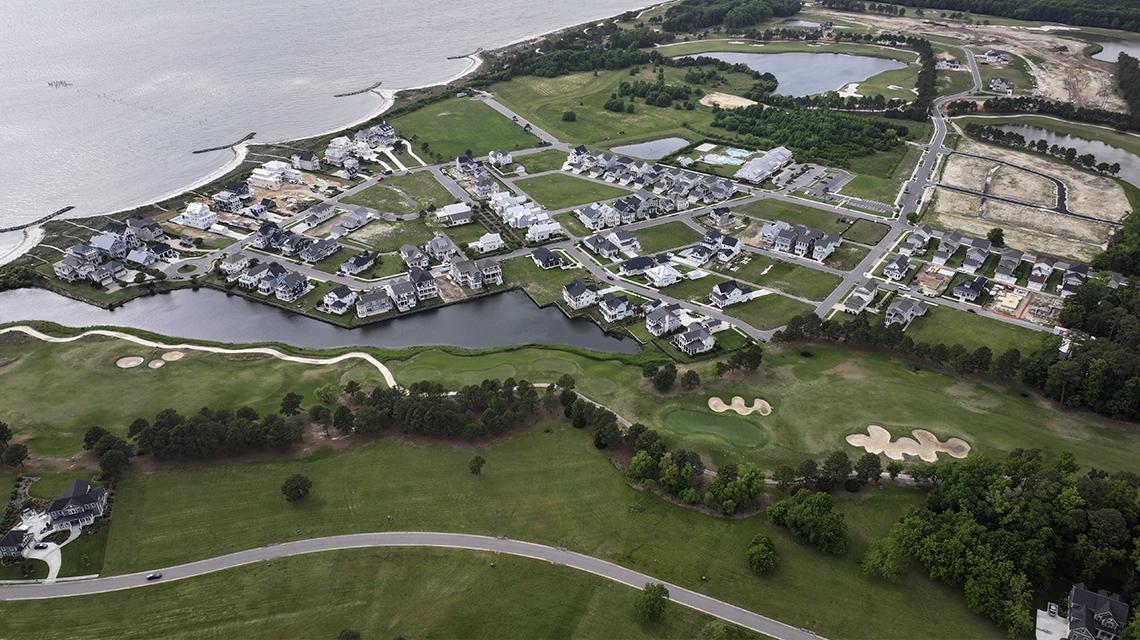 Aerial view of Bay Creek master-planned coastal community with golf courses, waterfront homes, and amenities that boost EB5 investor security.