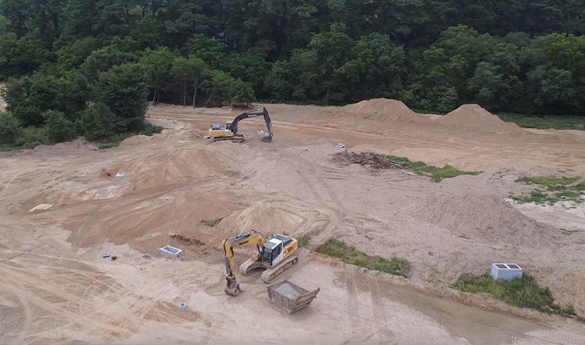 Excavators and earthmoving equipment at Bay Creek construction site, highlighting ongoing infrastructure work for EB5 residential development.