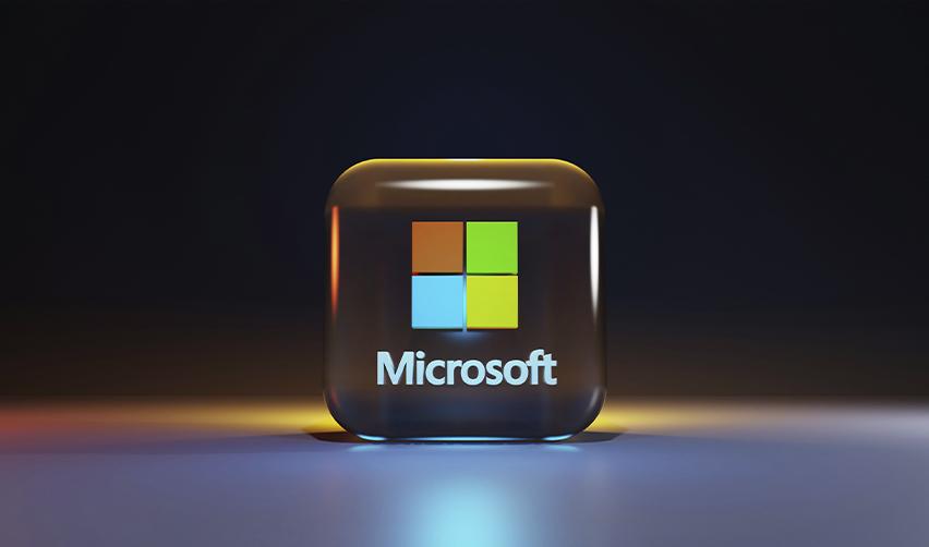 3D Microsoft logo glowing against a dark background, representing Microsoft’s role as a leading H1B employer in the U.S. tech sector.