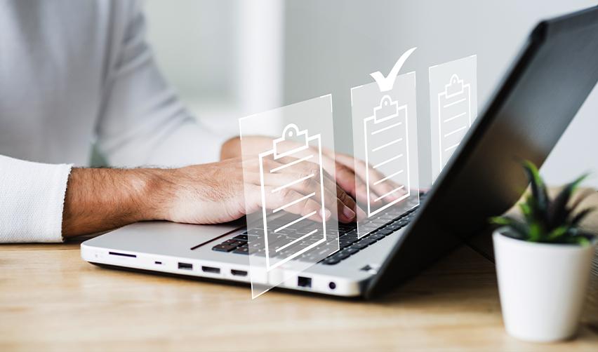 Investor using a laptop with checklist graphics, symbolizing the process of preparing EB5 source of funds documents and staying organized for USCIS requirements.