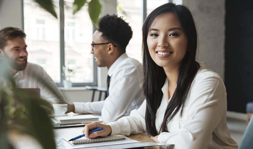 A foreign professional attending a workplace meeting in the United States, illustrating successful EB5 investors integrating into their careers.