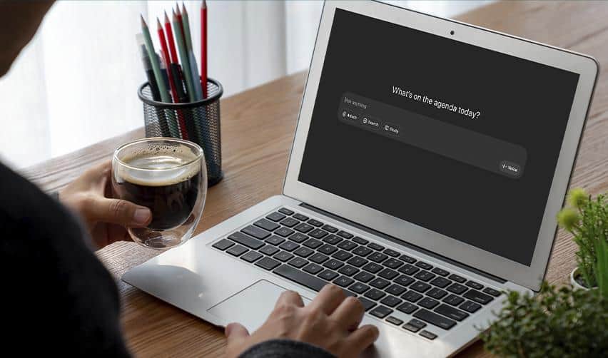 An investor researching EB5 immigration attorneys with ChatGPT while holding a cup of coffee, representing thoughtful preparation and decision-making.