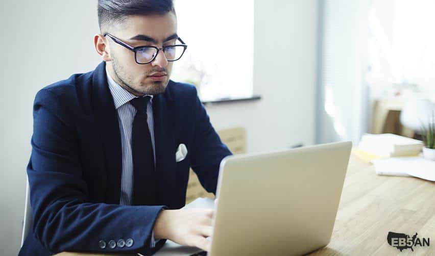 A professional analyzing EB5 investment and attorney options on a laptop, representing EB5AN’s commitment to guiding investors through every stage.