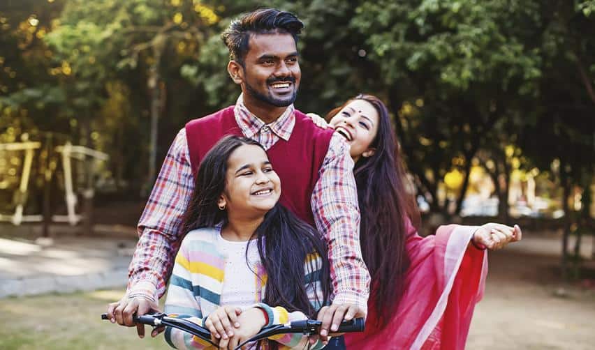 An Indian family enjoying time together in a park, representing the freedom and stability EB5 investors gain after moving to the United States.