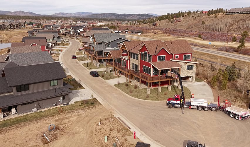 A large red house with a truck parked on the side of it