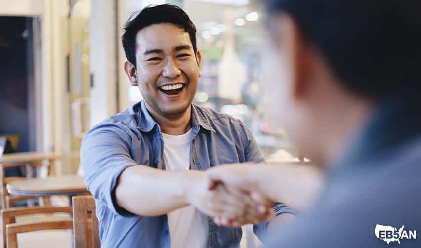 An EB5 investor shaking hands with a regional center representative in a professional setting, symbolizing guidance, trust, and support throughout the EB5 immigration process.