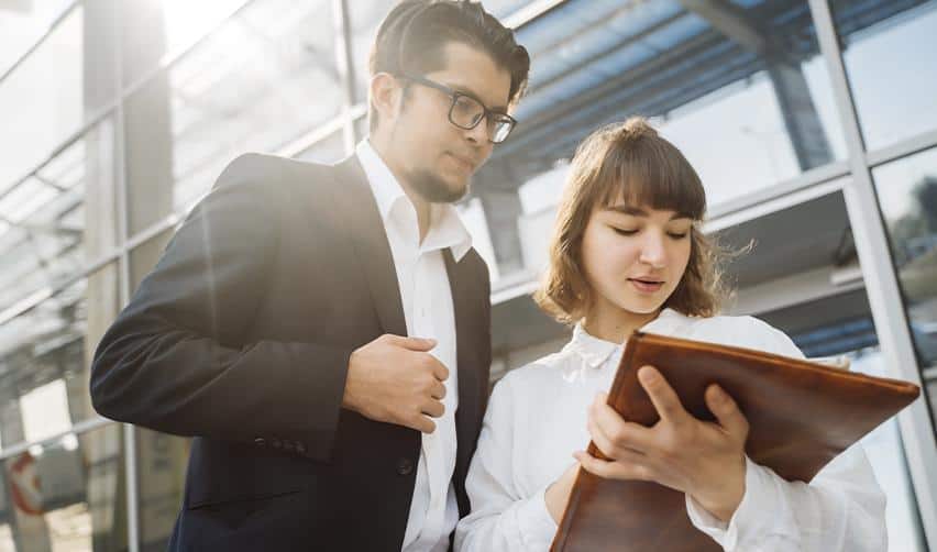 Two professionals reviewing documents together, illustrating EB5 project oversight, compliance review, and investor due diligence for rural EB5 investments.