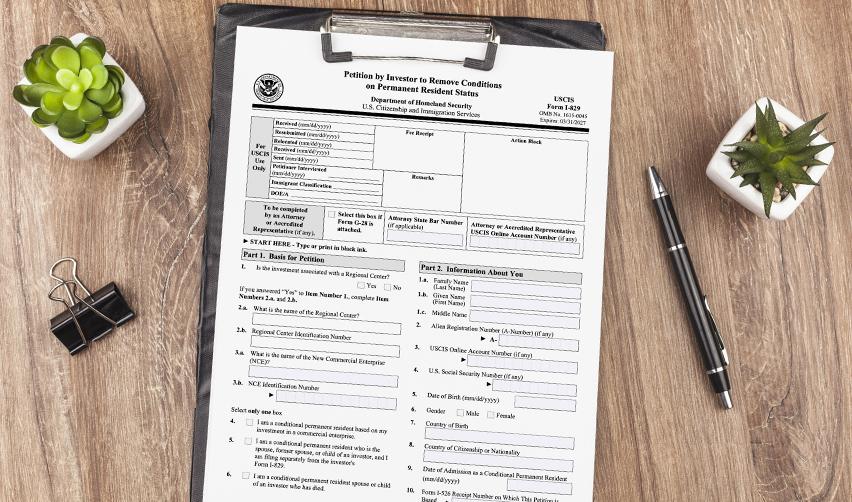 Form I-829 petition displayed on a clipboard, showing the final step in the EB5 process to remove conditions and obtain permanent resident status.